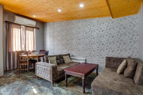 a living room with a couch and a table at Aleqs in Tbilisi City