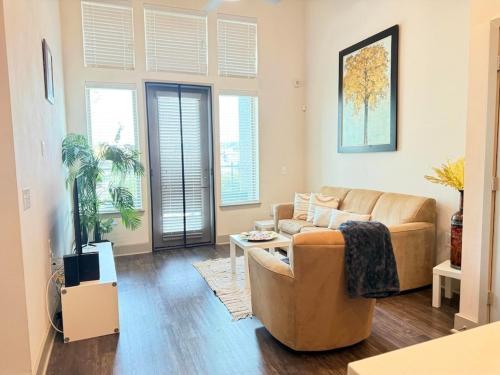 a living room with a couch and a table at Charming 1-bedroom apartment in terrific Frisco next to Toyota Stadium with WiFi & fitness in Frisco