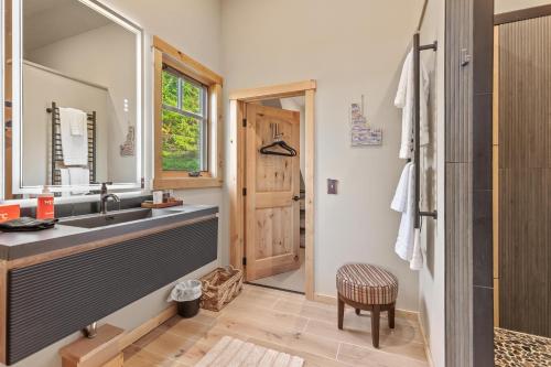 a bathroom with a sink and a large mirror at 818Forever in Lignite