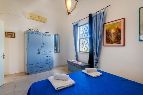 Postel nebo postele na pokoji v ubytování Palazzo Sabella Tommasi