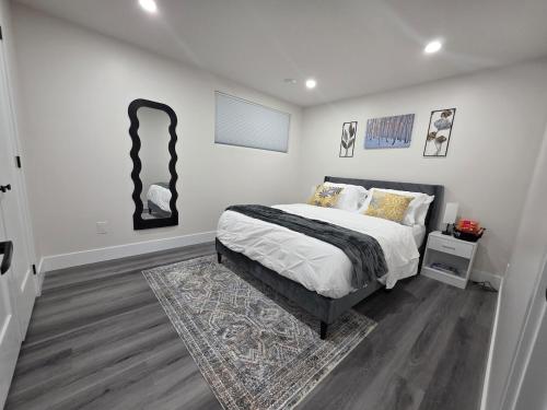 a bedroom with a bed and some pictures on the wall at Cozy Haven Suite in Moncton