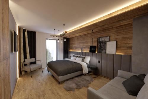 a bedroom with a bed and a couch at Jezerní Rezidence in Železná Ruda