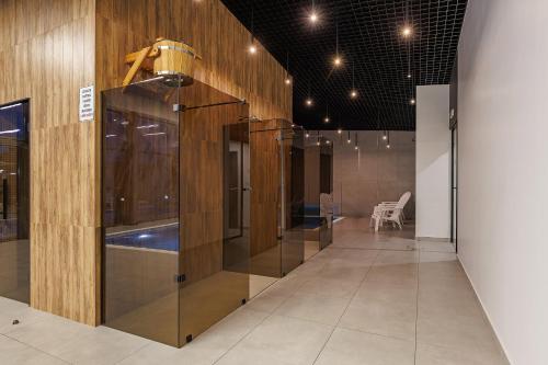 a hallway with a row of glass cases in a building at Вілла "Синевір" in Skhidnitsa