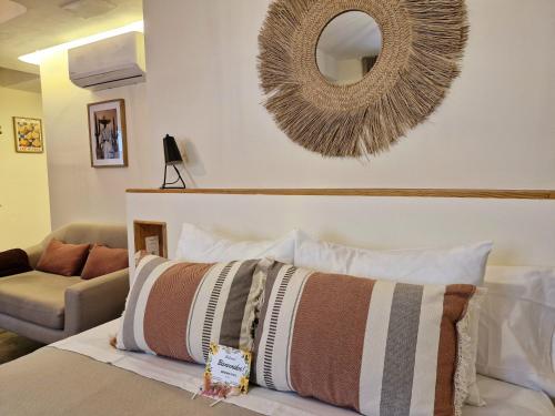 a bedroom with a bed with a mirror on the wall at Rooms Vita in Granada