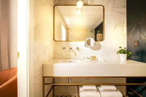 a bathroom with a sink and a mirror at The Cumberland by NEU Collective in Valletta