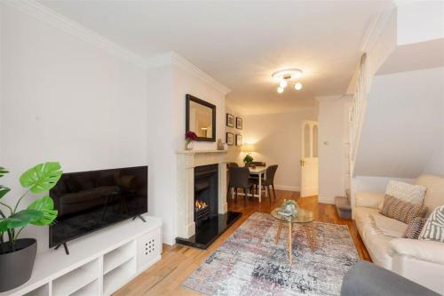 a living room with a television and a fireplace at GuestReady - Coastal Charm near Sandymount Beach in Dublin
