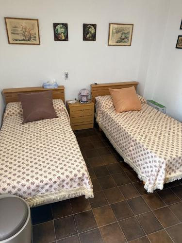 two beds sitting next to each other in a room at Arenal-Inalko in Alcossebre