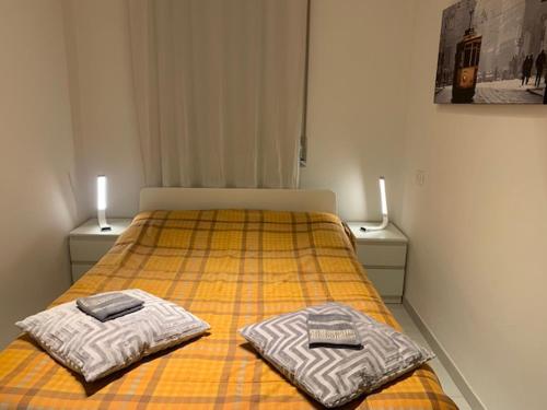 a bedroom with a bed with two towels on it at Ripalta House in San Donato Milanese