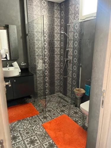 a bathroom with a shower and a toilet and a sink at Villa Zaara in Sehib Foukani