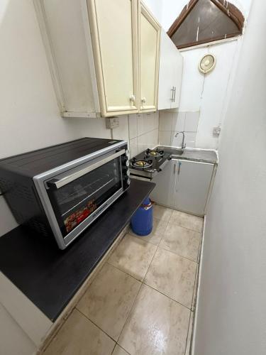 a small kitchen with a toaster oven on a counter at استديو الخالديه in Abu Dhabi