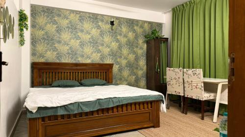 ein Schlafzimmer mit einem Bett und einer grünen Wand in der Unterkunft Emaar Homestays in Hyderabad