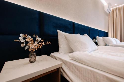 a bedroom with a vase of flowers on a table at Or Haganuz in Dobrovelychkivka