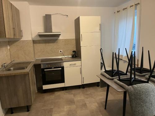 a kitchen with a stove and a sink and a refrigerator at Home15 Kassel in Kassel