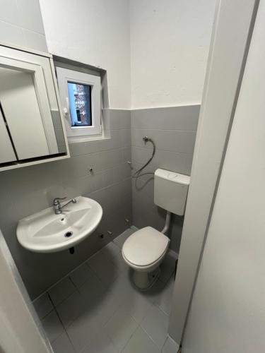 a small bathroom with a toilet and a sink at Home15 Kassel in Kassel