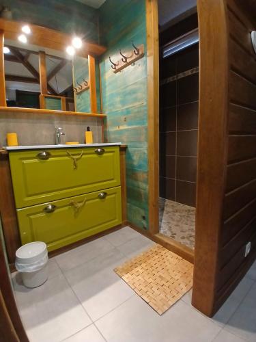 a bathroom with a green sink and a shower at Villa Ti Colibri in Bouillante