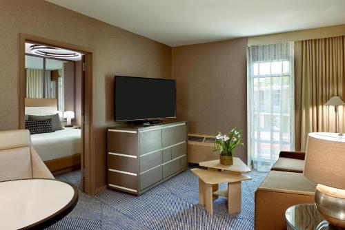 a hotel room with a bed and a flat screen tv at Hotel Zoe Fisherman's Wharf in San Francisco