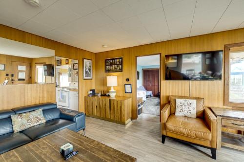 a living room with a couch and a table at Beachfront Cottage on Seaside Promenade with Hot Tub in Seaside