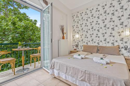 a bedroom with a bed and a balcony at SALV3R Hotel in Athens