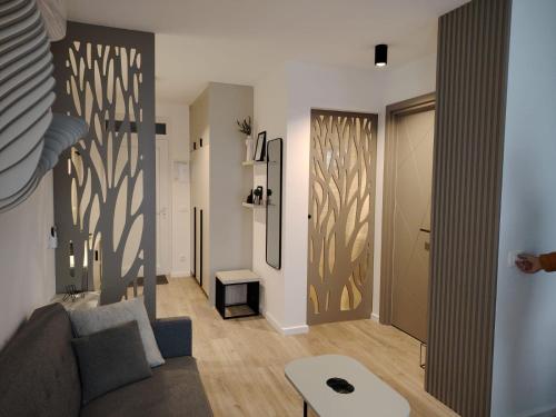 a living room with a couch and a table at Apartman „Karolina” in Nova Gradiška