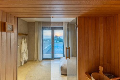a room with a glass door to a bedroom with a balcony at Sella Marron in Selina