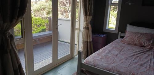 Postel nebo postele na pokoji v ubytování Matai Whetū - Stargazer Tutukaka