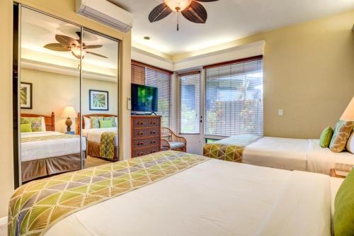 a bedroom with two beds and a mirror at Kapalua Bay Villas 2 Free Rental Cars KBM Resorts Premium Bay Villa 2 Units 3 Bedrooms ML-1604 in Honokahua