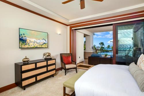 a bedroom with a bed and a chair and a window at Montage Kapalua Bay 2 Free Rental Cars KBM Resorts Beautiful Villa At Montage Kapalua Bay 2 Units 6 Bedrooms ML-1507 in Honokahua