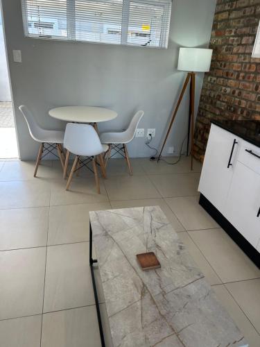 a dining room with a table and chairs at Home Away From Home 6 minutes away from beach in Cape Town