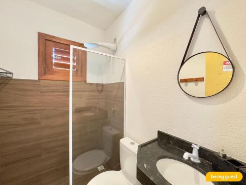 a bathroom with a toilet and a mirror at Beach-Home Pontal de Maceió in Fortim
