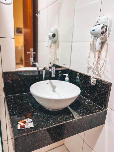 a bathroom counter with a sink and a mirror at Pousada do Imperador in Piranhas
