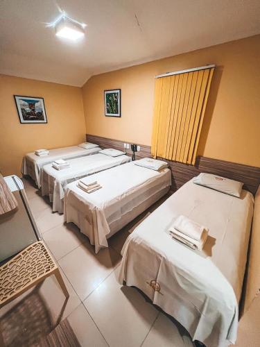 a hospital room with four beds in a row at Pousada do Imperador in Piranhas