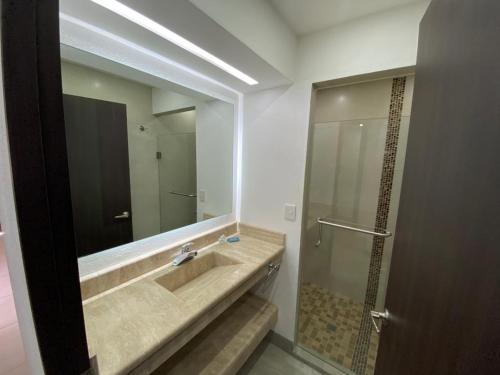 a bathroom with a sink and a mirror at Hotel María del Carmen in Jalpan de Serra