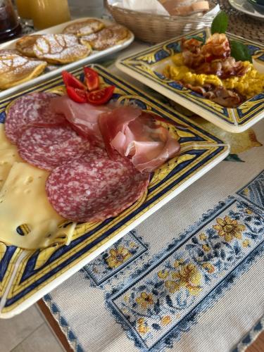 a table with three plates of different types of food at mentamarina in Porto Recanati