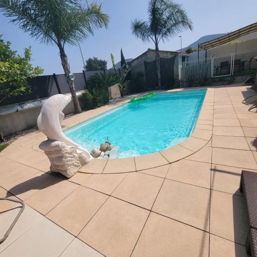 a swimming pool with a statue of a mermaid at Casa Leone 83 in Solliès-Pont