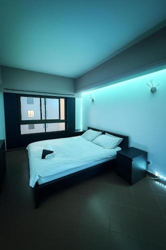 a bedroom with a large bed and a blue light at 2 Bedroom City Centre Gibraltar in Gibraltar