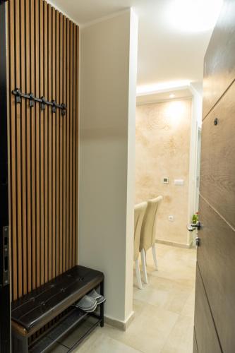 a hallway with a door and a table and chairs at Sirmium stay in Sremska Mitrovica