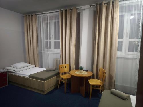 a room with a bed and a table and a window at Sami Swoi Kutno in Kutno