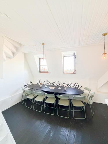 a large white room with a table and chairs at Le FauBourg Suites in Antwerp