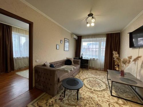 a living room with a couch and a table at Воскресенская 1 Набережная 2 кв in Dnipro