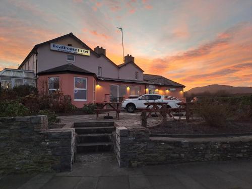 a building with a car parked in front of it at Boathouse Hotel in Holyhead
