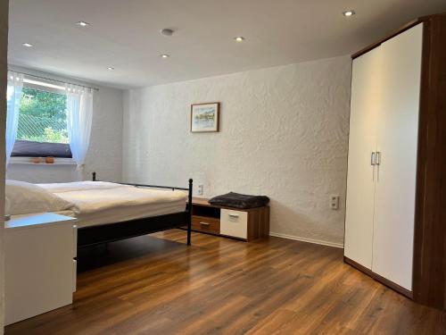 a bedroom with a bed and a wooden floor at Wohlfühlnest im Ahornweg in Gerolstein