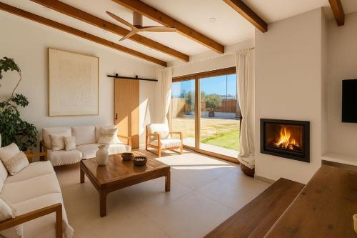 a living room with a couch and a fireplace at Villa Salinas Beach Home Natural Park in La Manga del Mar Menor