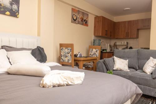 a living room with a bed and a couch at JAS Stays in Nanyuki