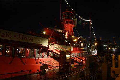a large red boat is docked at night at Das Feuerschiff in Hamburg