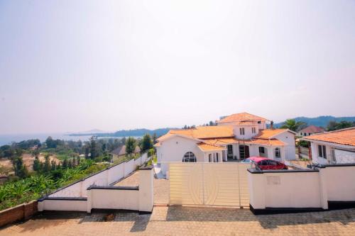 a view of a house with a fence at Elegant Lakeside Villa in Kibuye, Rwanda in Mwendo