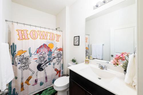 a bathroom with a sink and a shower curtain at TONKA in Austin
