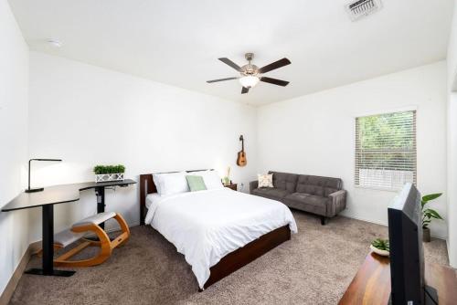a bedroom with a bed and a ceiling fan at TONKA in Austin