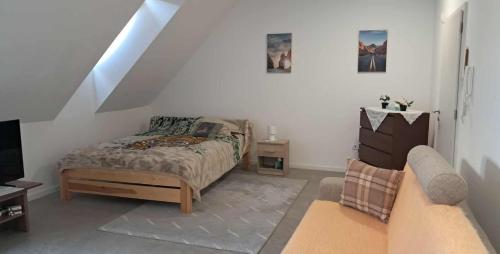 a bedroom with a bed and a couch at Atkacs Home in Győr