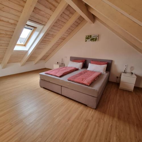 a bedroom with a bed in a attic at Ferienwohnung mit Balkon in Oberelsbach