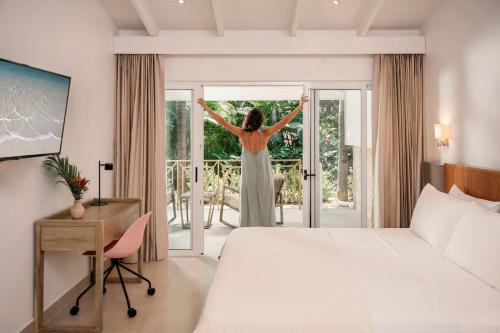 a woman in a hotel room looking out the door at Astra Hotel Boutique in Nosara
